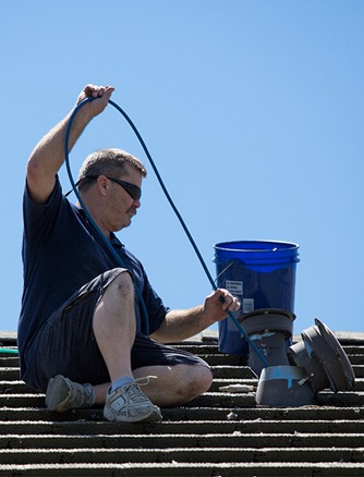 Randy cleaning a roof dryer vent